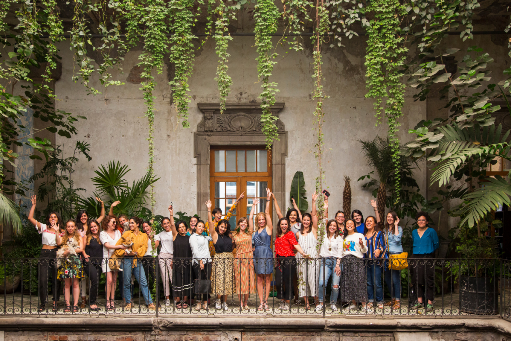 Group of traveling women with fists in the air, clearly excited to be traveling